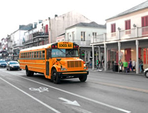 Image of yellow school bus driving on road